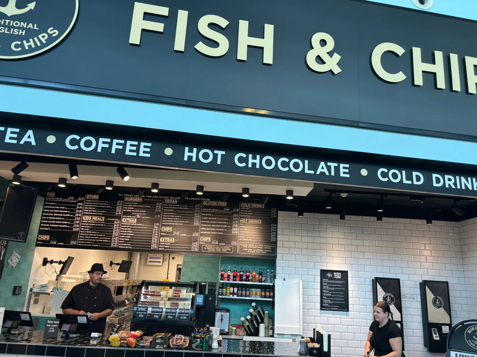 The Burnetts counter under the Fish and Chips sign at Folkestone Services