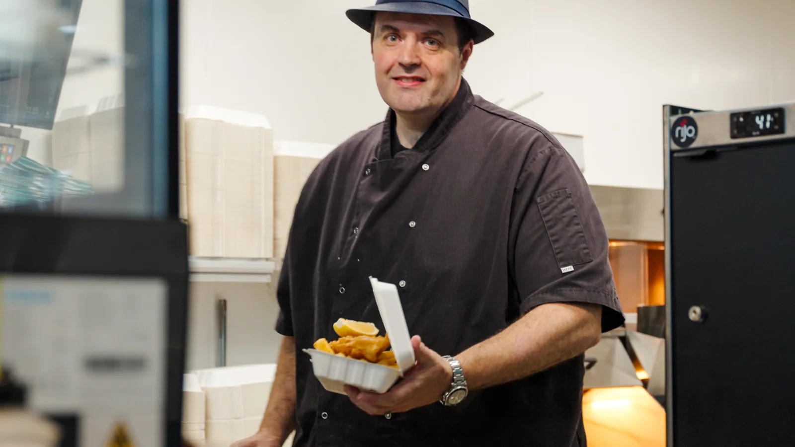Andy Burnett holding a box of fish and chips